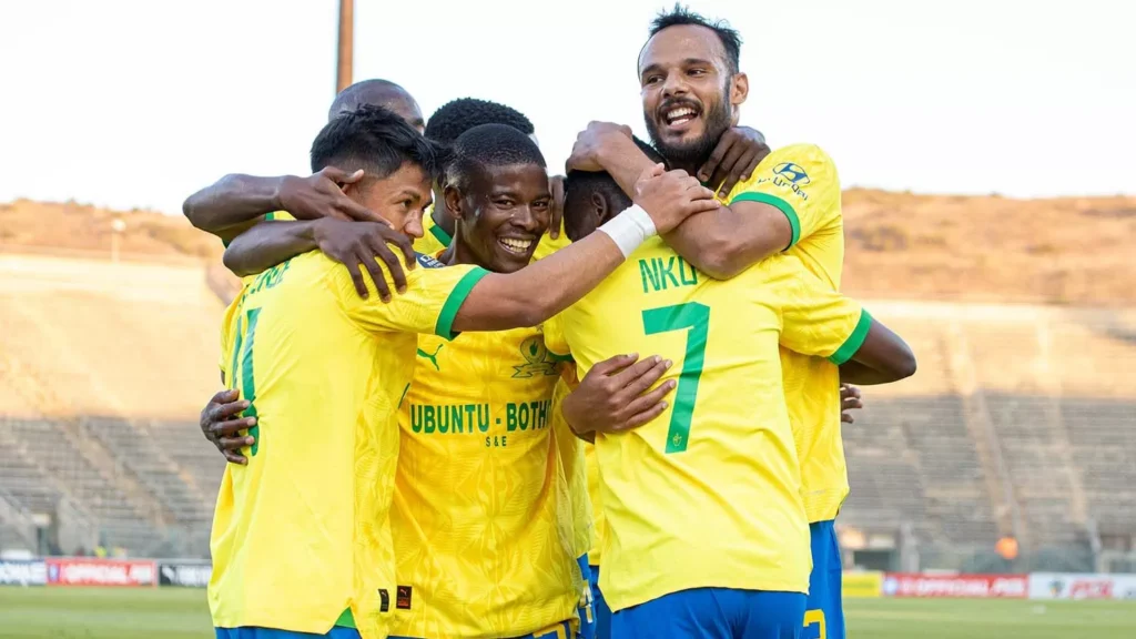 Neo Maema in celebratory mood with his Mamelodi Sundowns teammates.