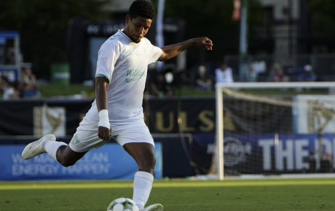 Jamie Webber kicking a ball during match