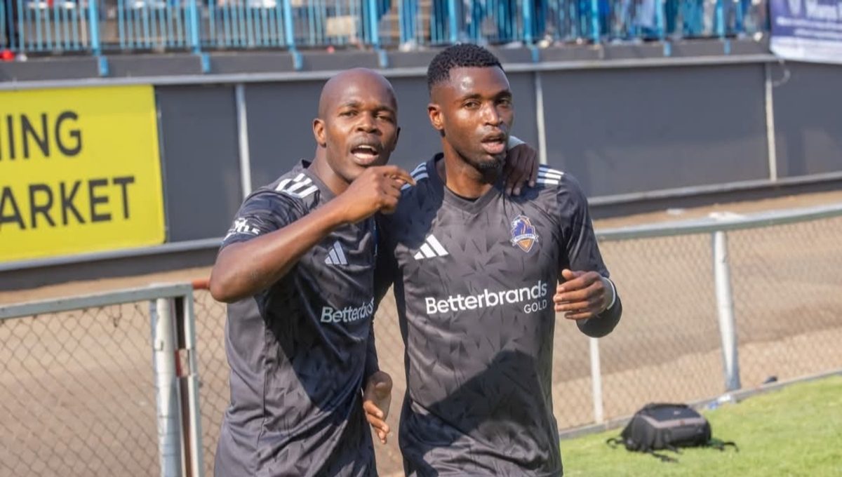 Knowledge and Walter Musona celebrating a goal