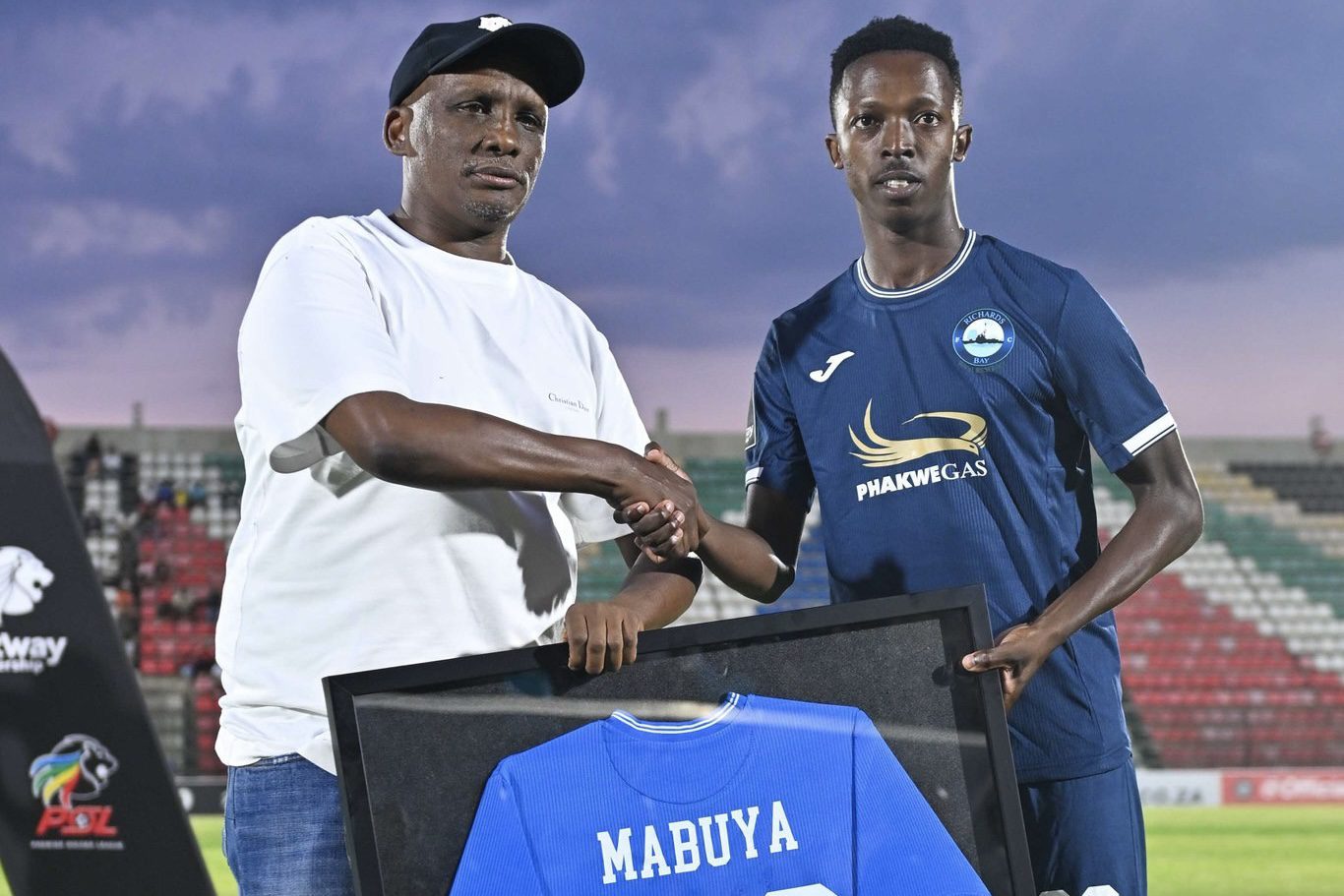 Lwandile Mabuya posing Richards Bay FC chairman, Jomo Biyela