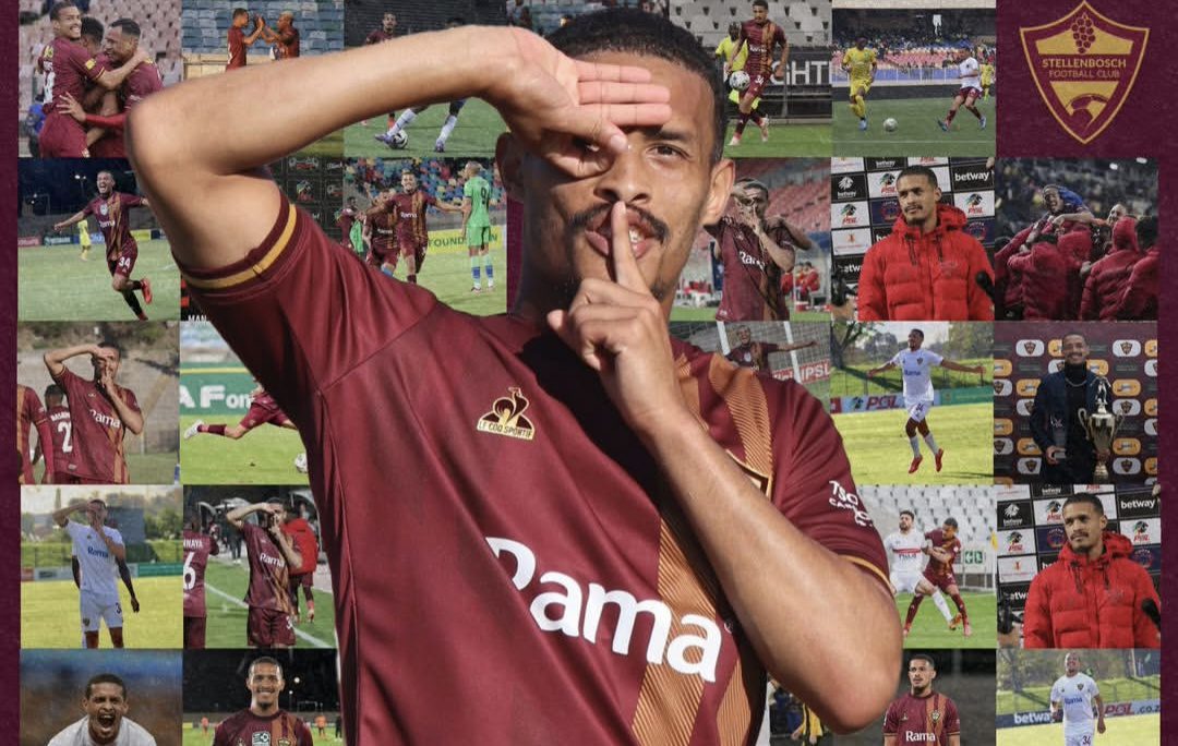 Devin Titus positing with his posters on the background