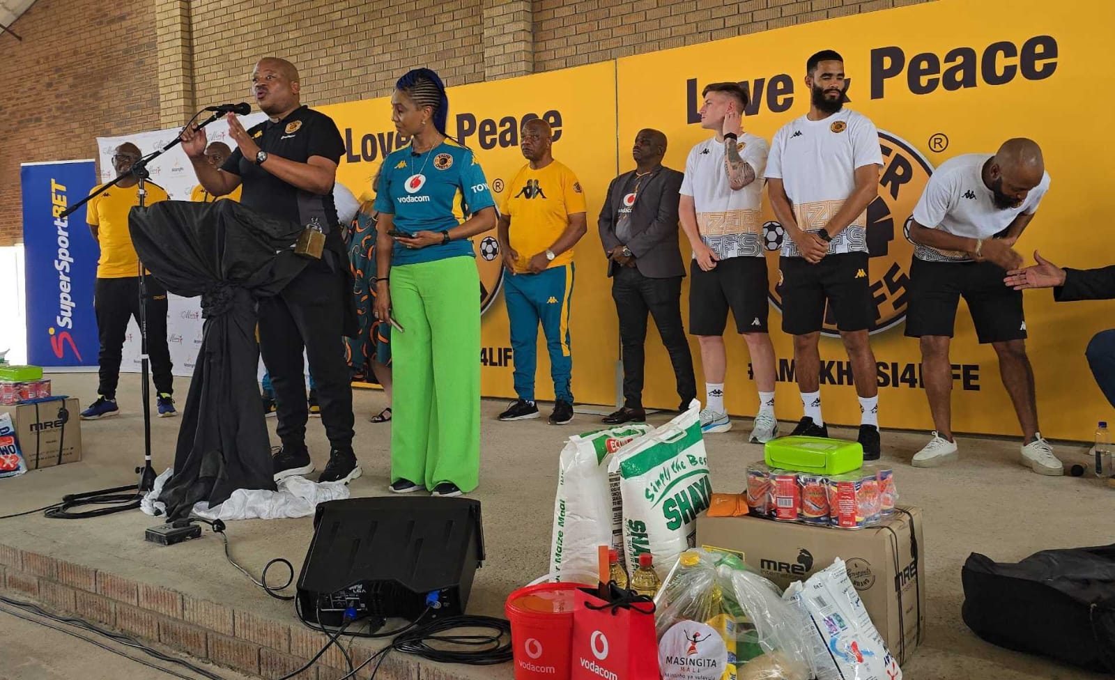Kaizer Chiefs Football manager Bobby Motaung with Kemiso Motaung and the club's players at the back