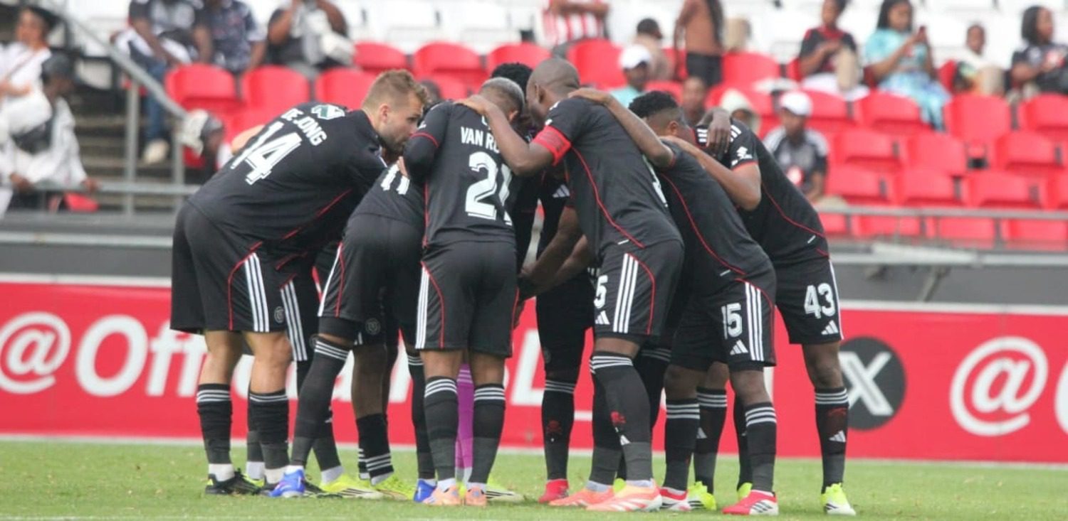 Orlando Pirates players gather for a war-cry