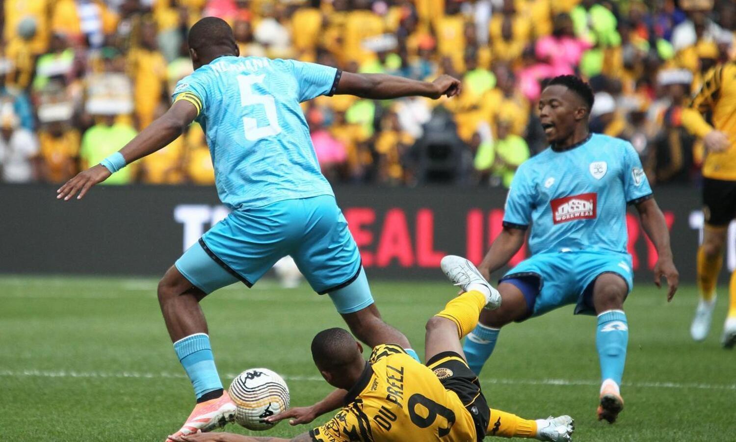 Durban City defender Siphamandla Ncanana controls the ball after disposessing Kaizer Chiefs striker Ashley du Preez as Emmanuel Jalai supports