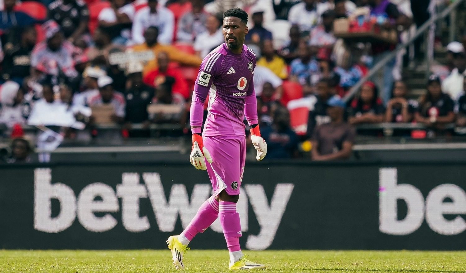 Sipho Chaine, Orlando Pirates goalkeeper walking on the pitch