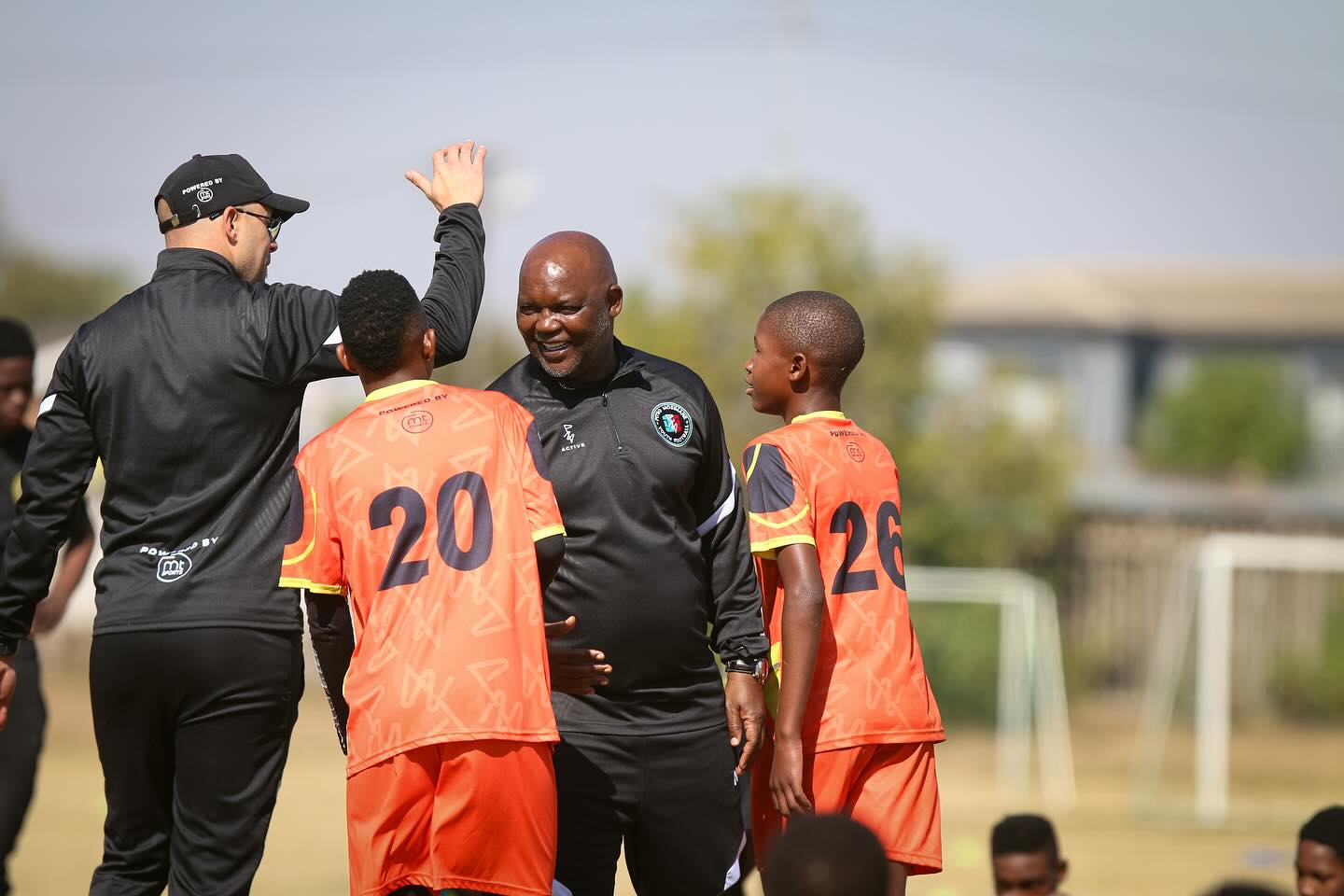 Coach Pitso Mosimane sharing a moment with players at the Pitso Mosimane Youth Football