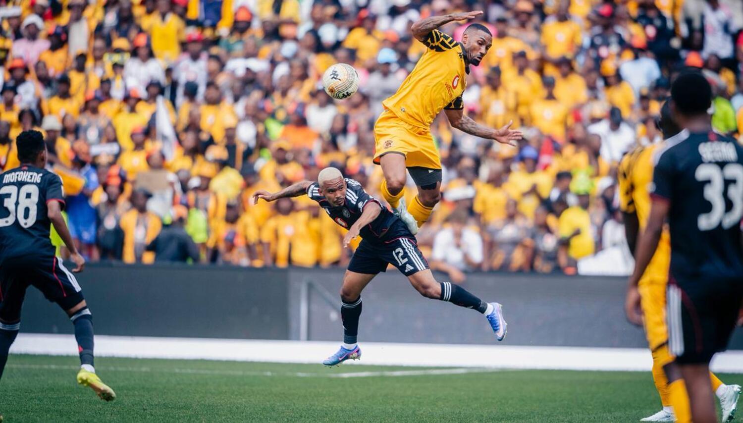 Kaizer Chiefs defender Inacio Miguel in an aerial challenge with Orlando Pirates winger Oswin Appollis