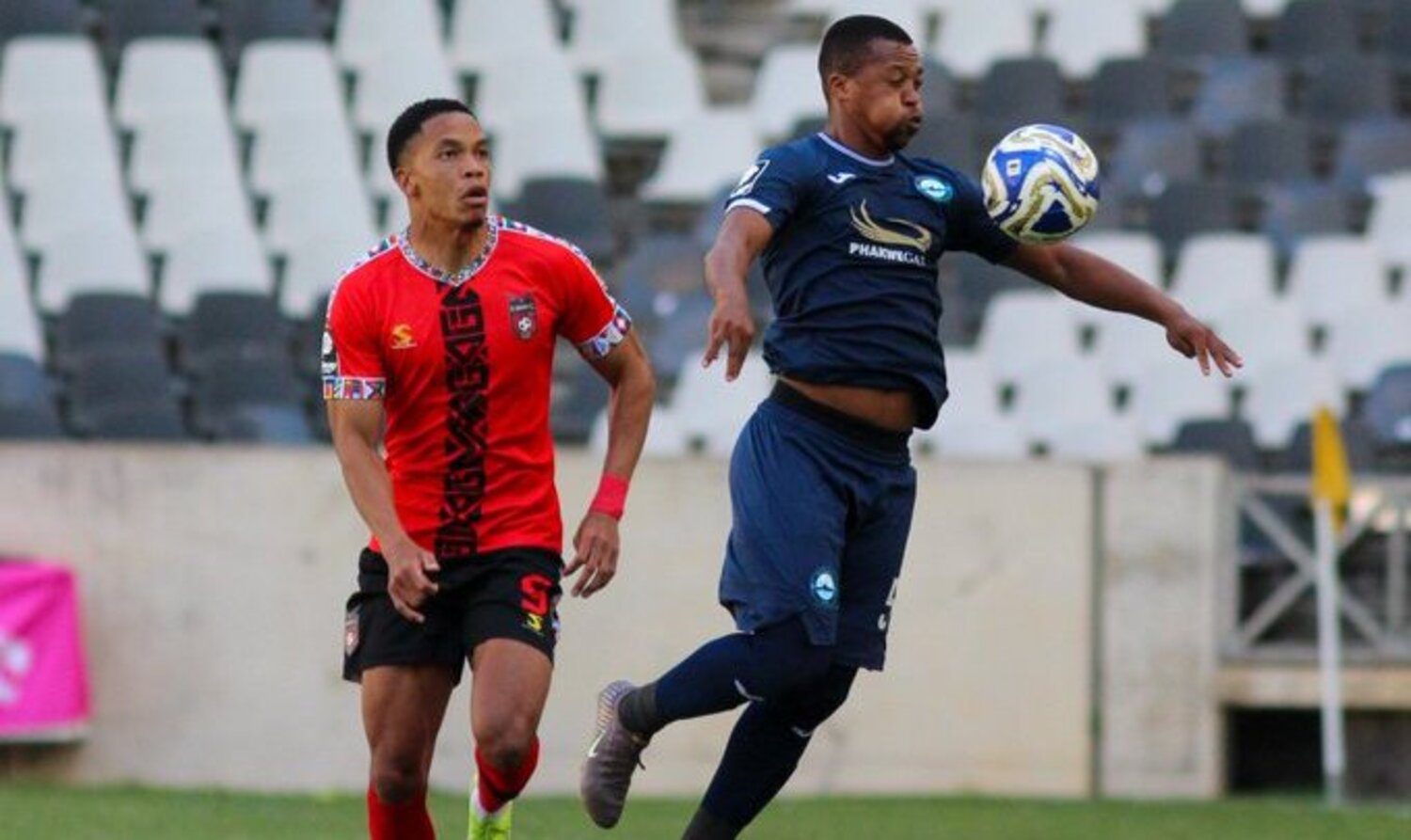 TS Galaxy striker Junior Zindoga challenging Richards Bay defender Thembela Sikhakhane