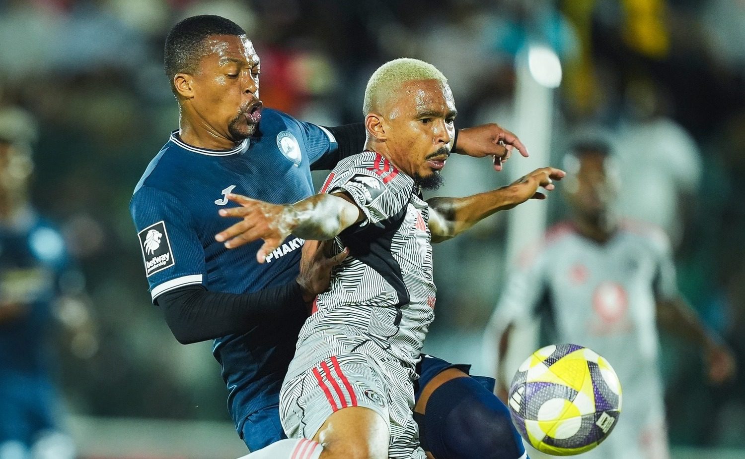 Richards Bay defender Thembela Sikhakhane tightly marks Orlando Pirates winger Oswin Appollis