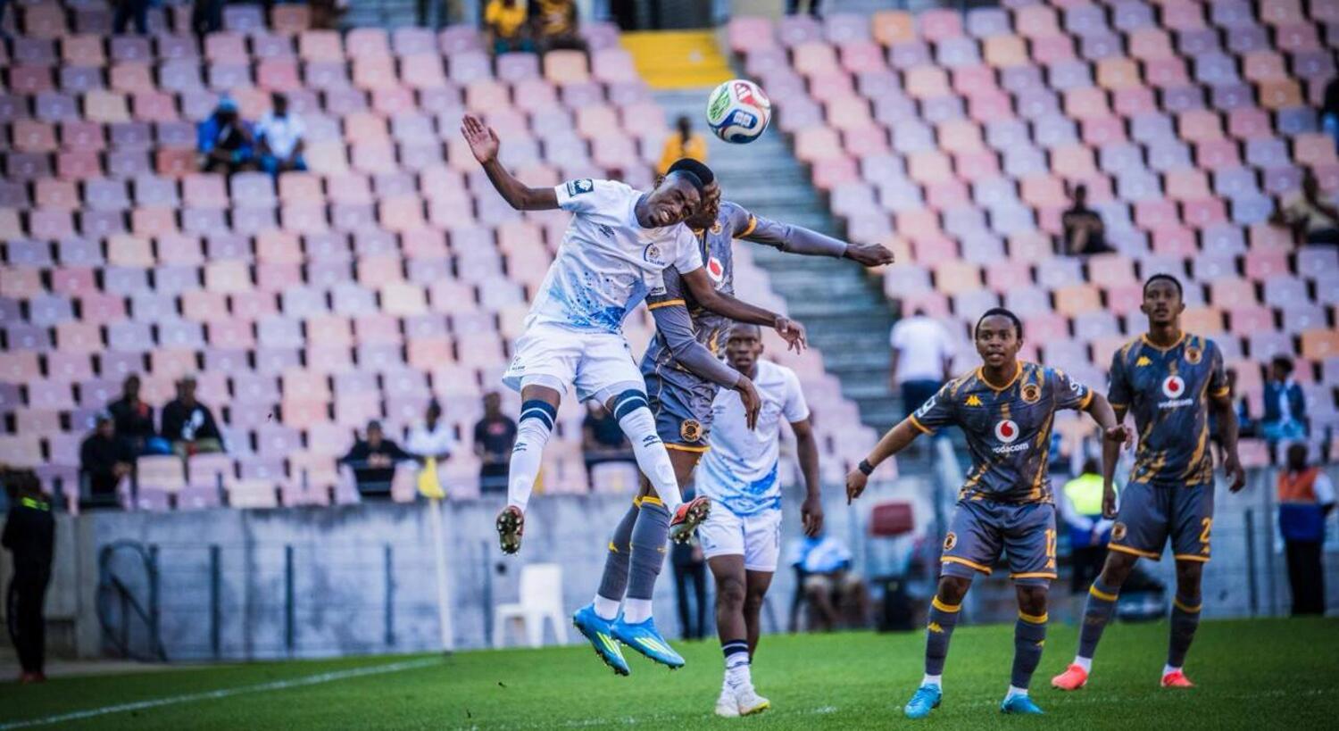 Kaizer Chiefs defender Thabiso Monyane jumps for the ball against an Orbit College player