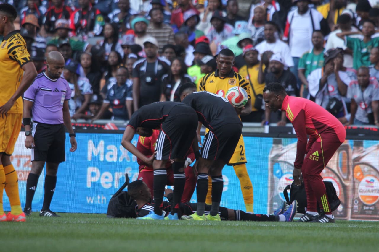 Tshepang Moremi of Orlando Pirates down injured surronding by his teammates
