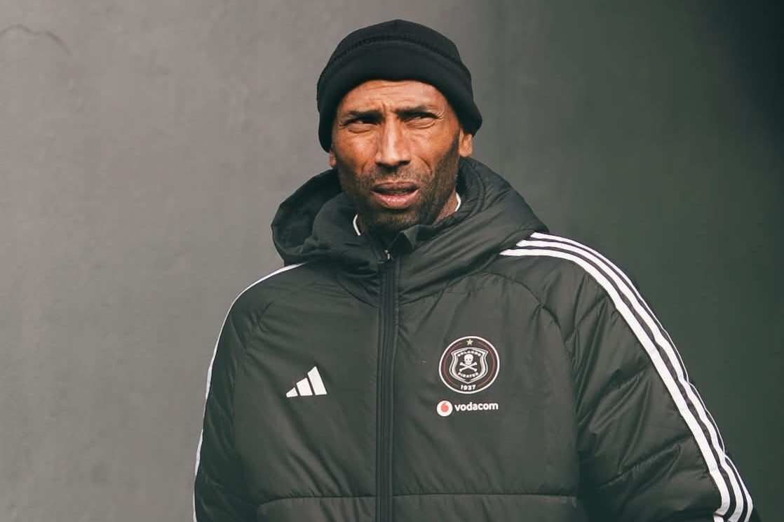 Abdeslam Ouaddou walking while wearing an Orlando Pirates jacket. 