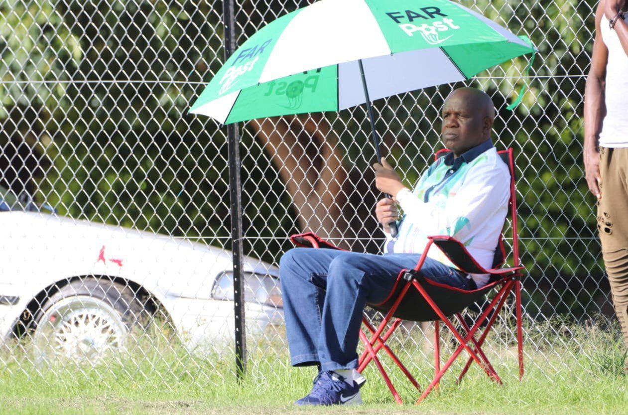 David Thidiela sitting down with a FARPost umbrella 