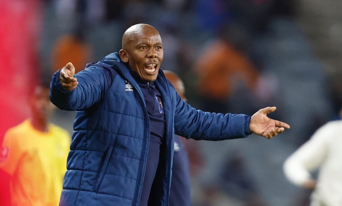Orbit College FC head coach Pogiso Makhoye on the touchline giving instructions to his players