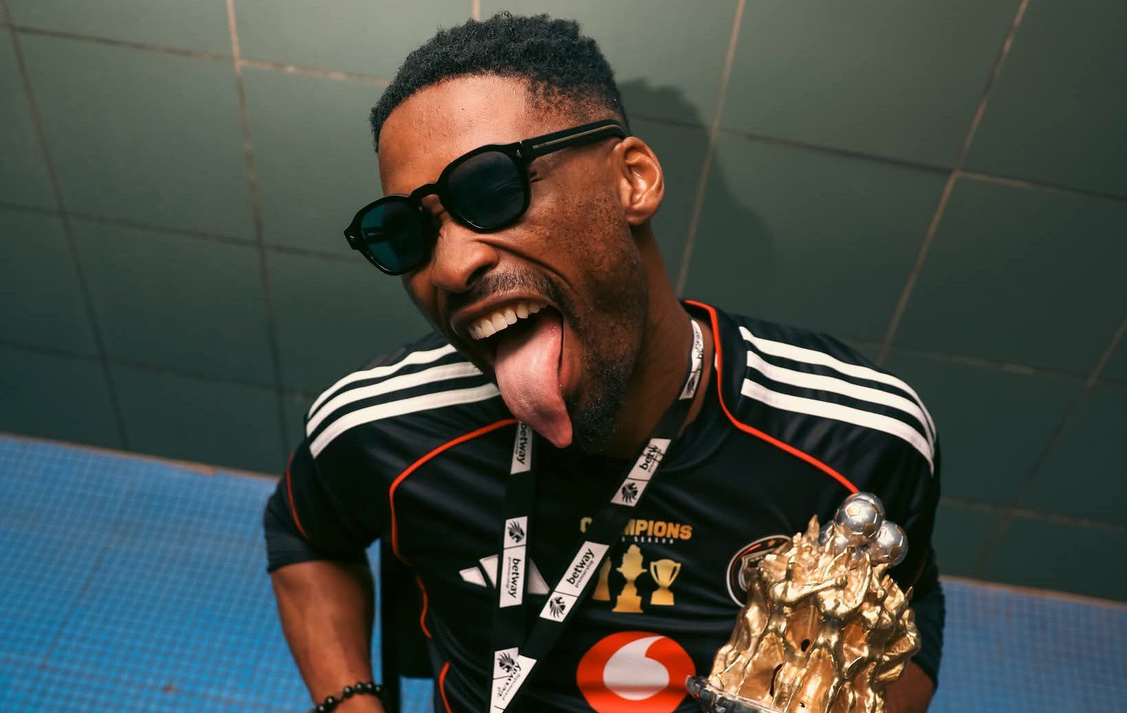 Orlando Pirates goalkeeper Sipho Chaine holding the Betway Premiership title