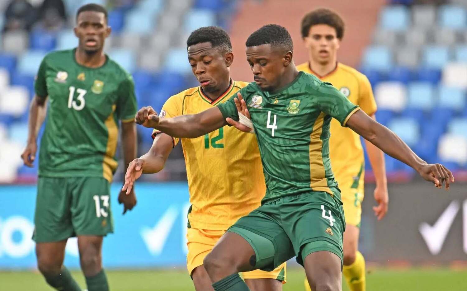 Bafana Bafana midfielder Teboho Mokoena under the challenge of Zimbabwe star Bill Antonio